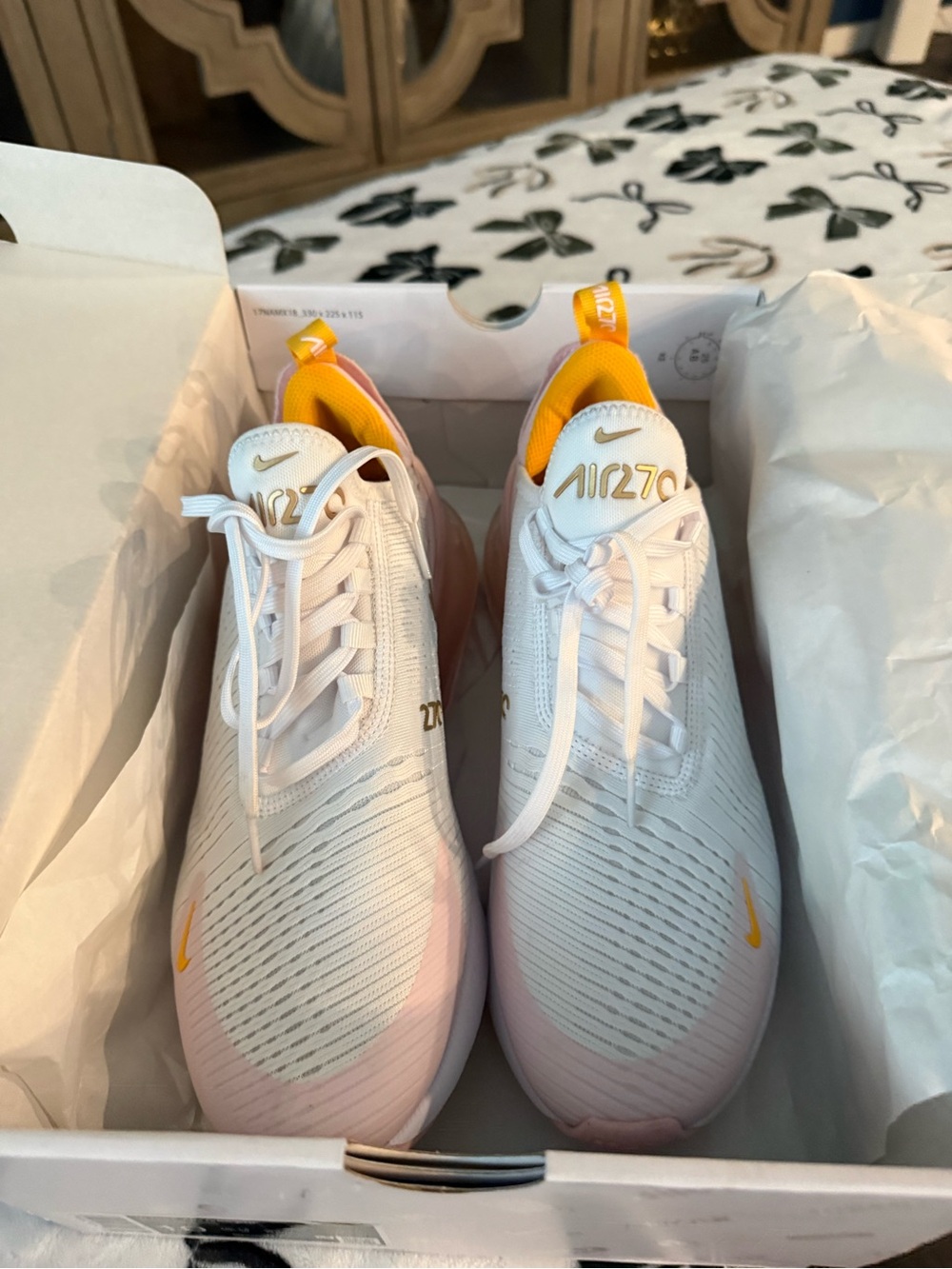 Nike white sneakers with pink and yellow accents
